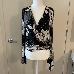 Cozy bell-sleeved, draped, tie-side floral and Aztec print top